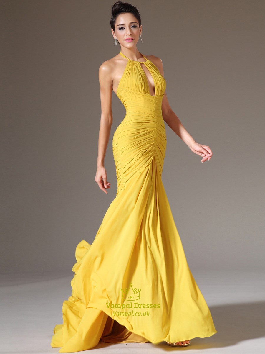 Side profile of the elegant yellow sleeveless prom gown.