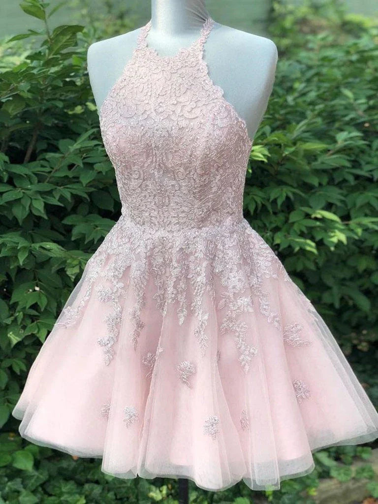 Woman wearing a light blue A-line halter neck short prom dress.