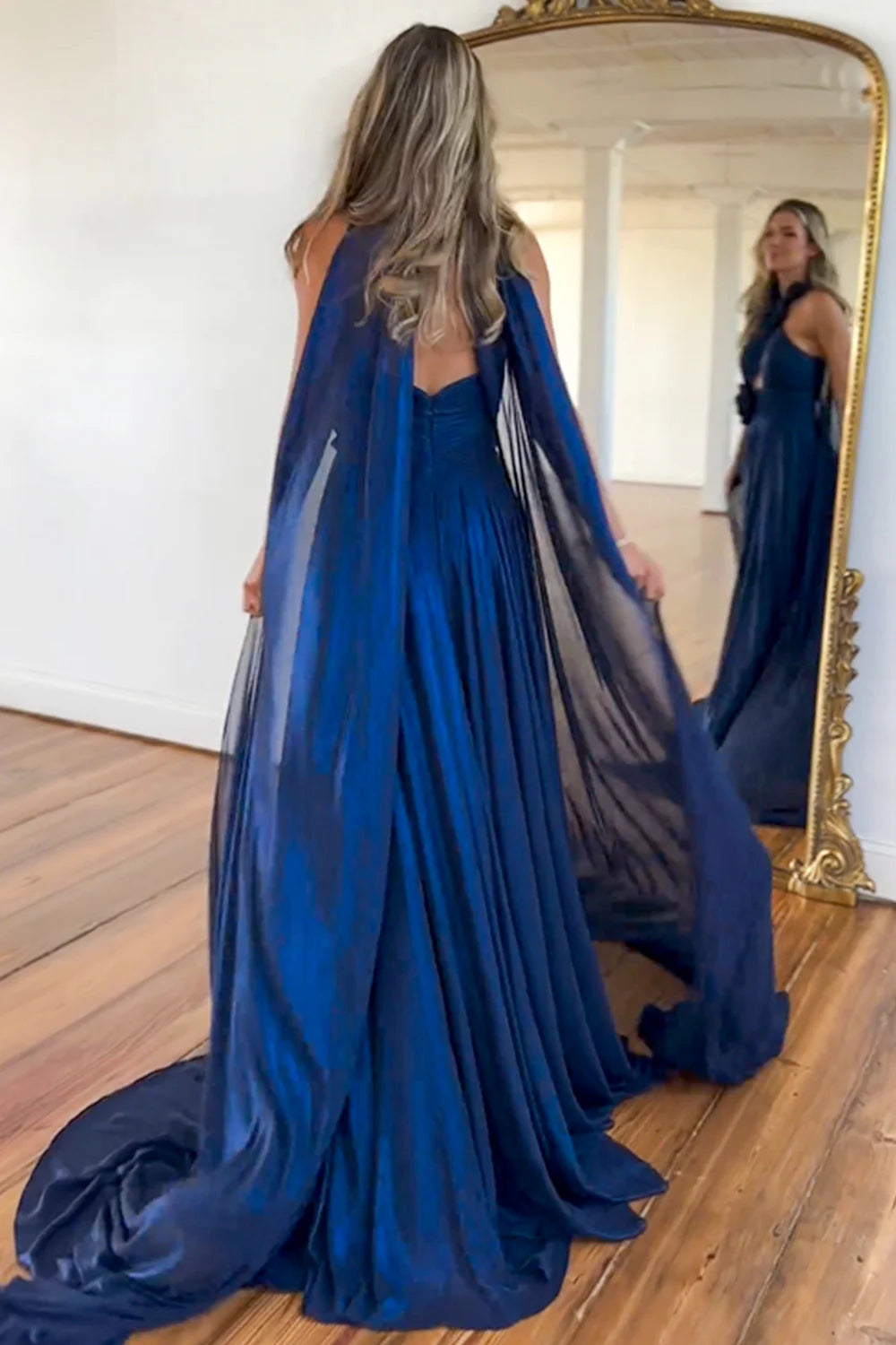 Back view of the navy A-line halter neck satin long formal dress, highlighting the elegant silhouette.