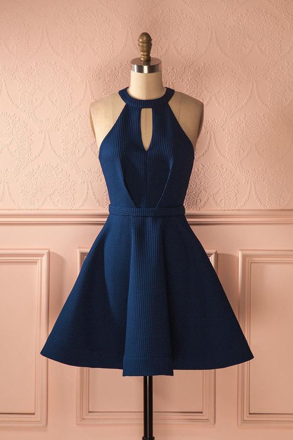 Model wearing a light blue A-line halter homecoming dress with open back.