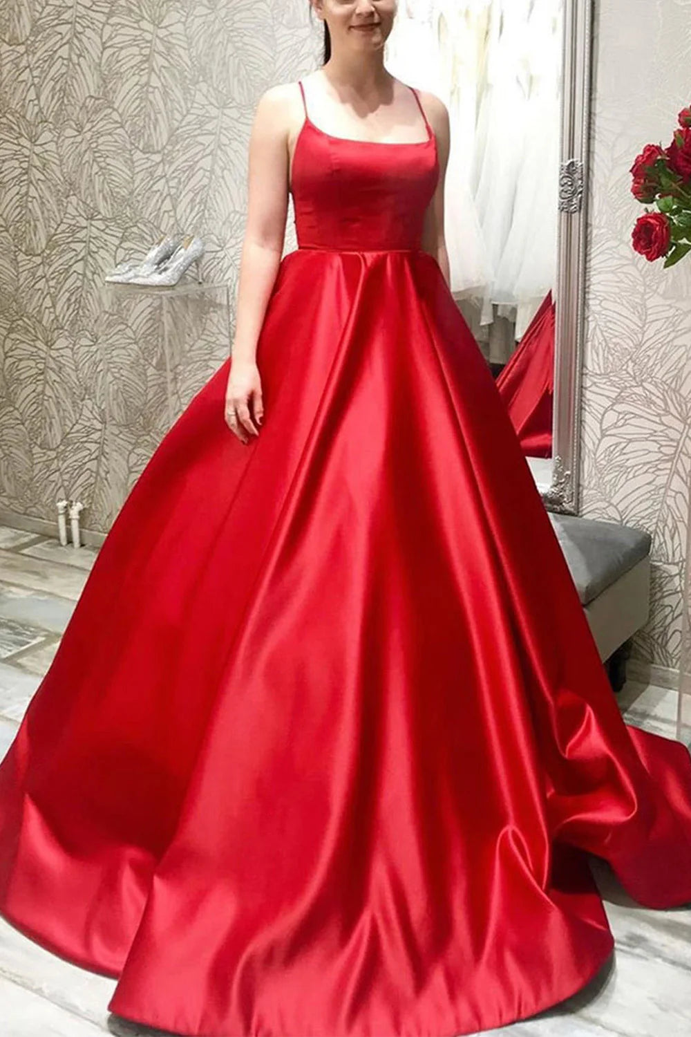 Model wearing a vibrant red A-line halter satin long formal gown.