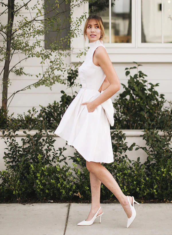 Elegant A-Line halter satin wedding dress with a large bow at the back.