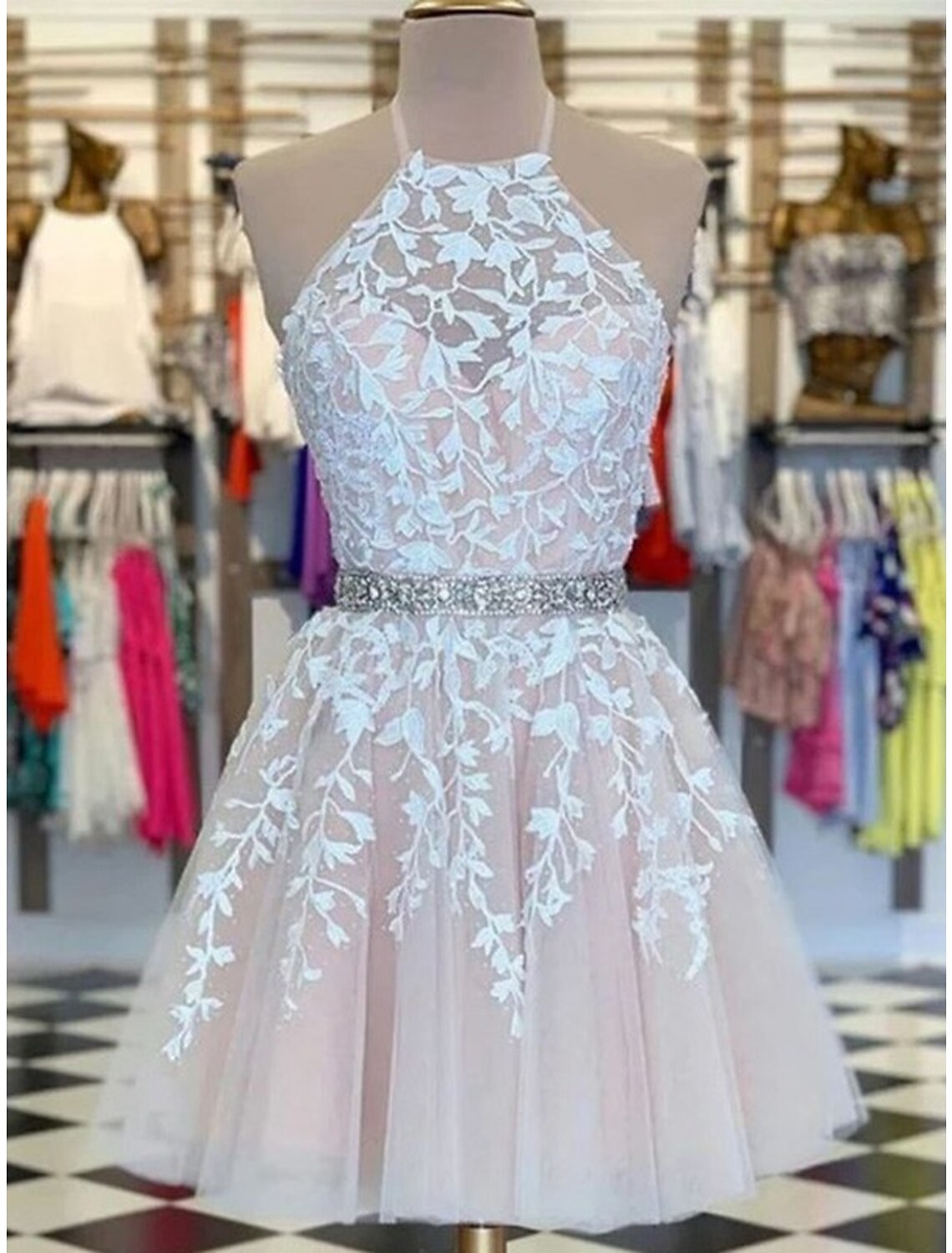 A-line halter homecoming dress with floral appliques on tulle fabric.