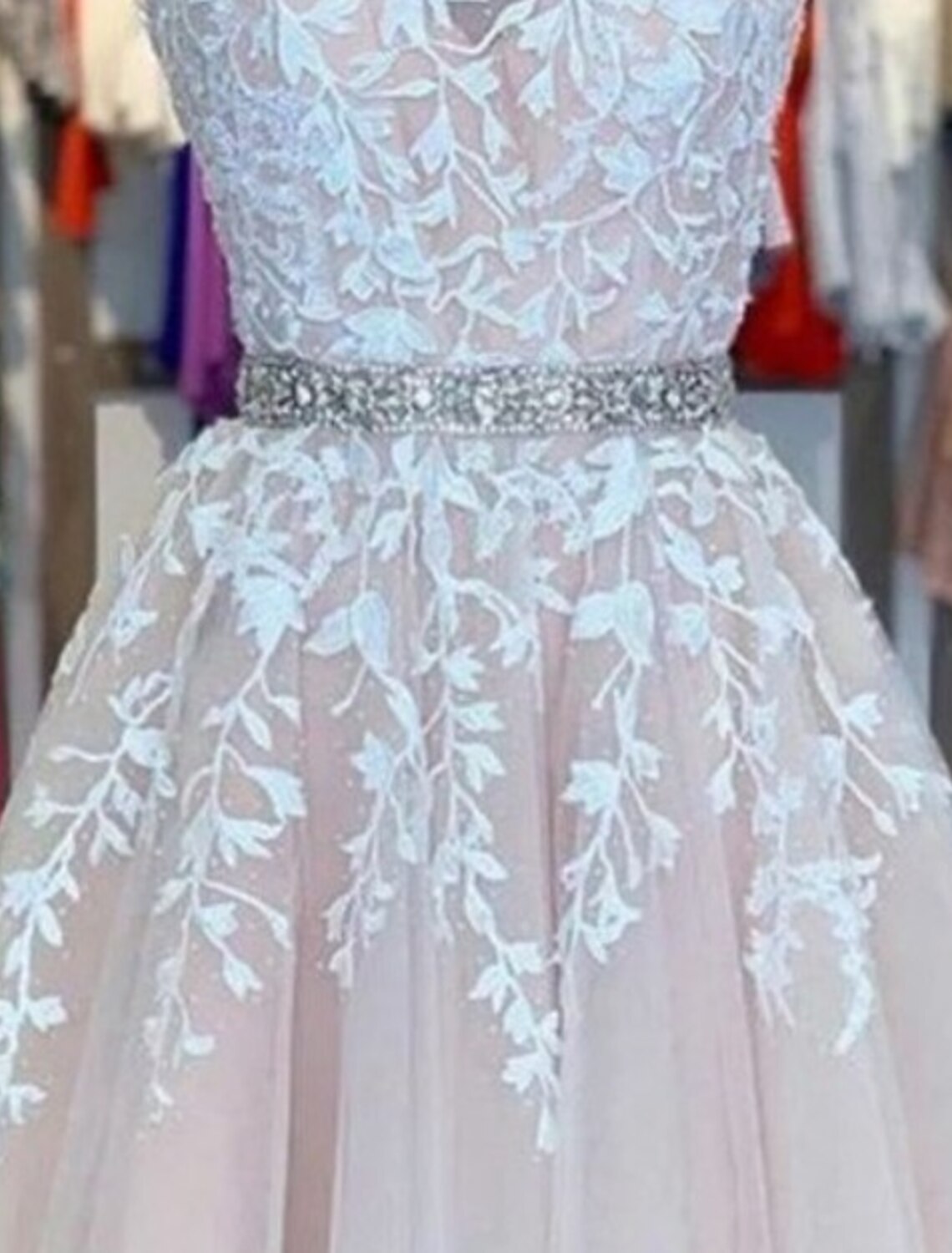 Close-up of the floral appliques and tulle fabric on the A-line homecoming dress.