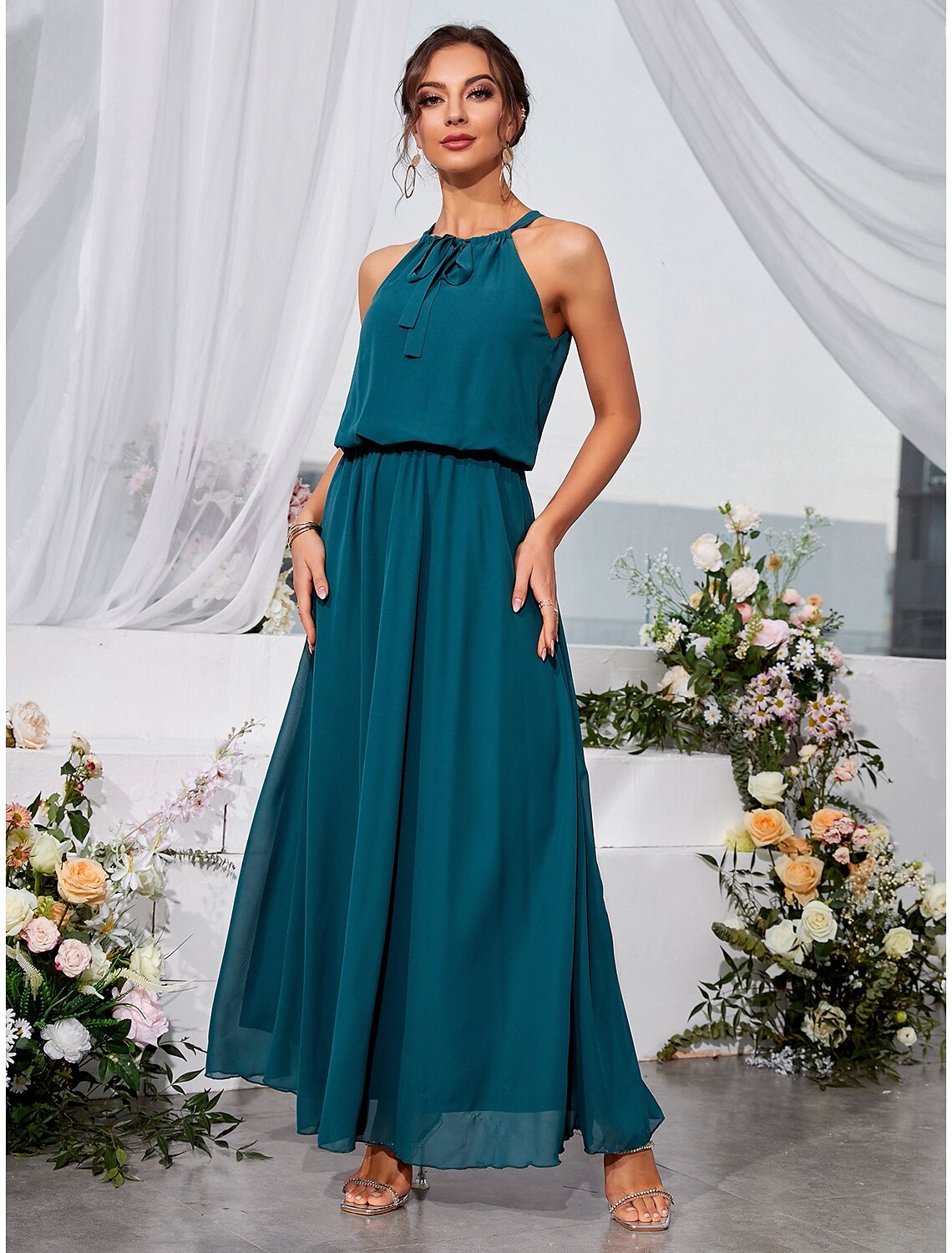 Back view of the sleeveless A-line dress with strappy details.