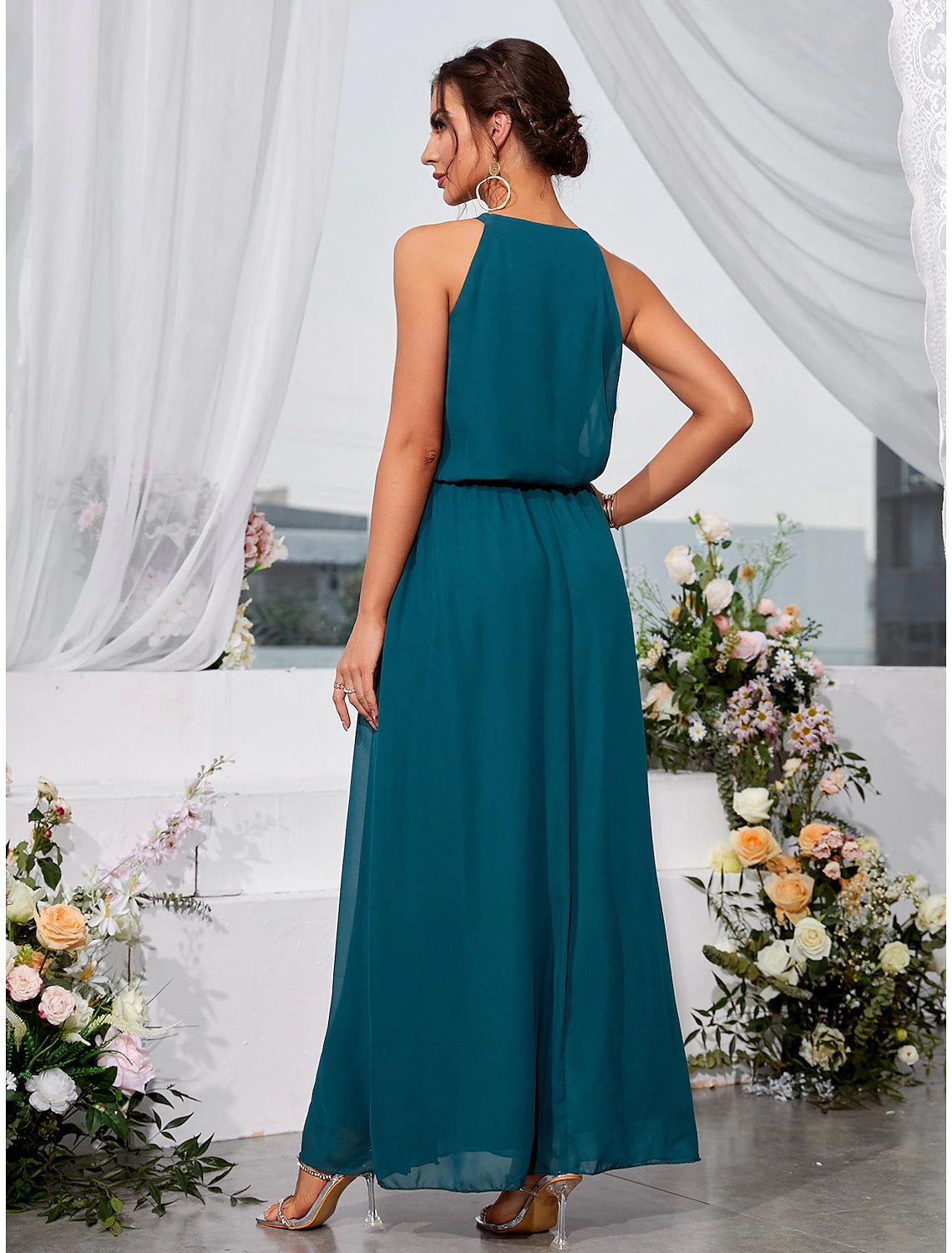 Close-up of the lace detail and halter neckline on the dress.