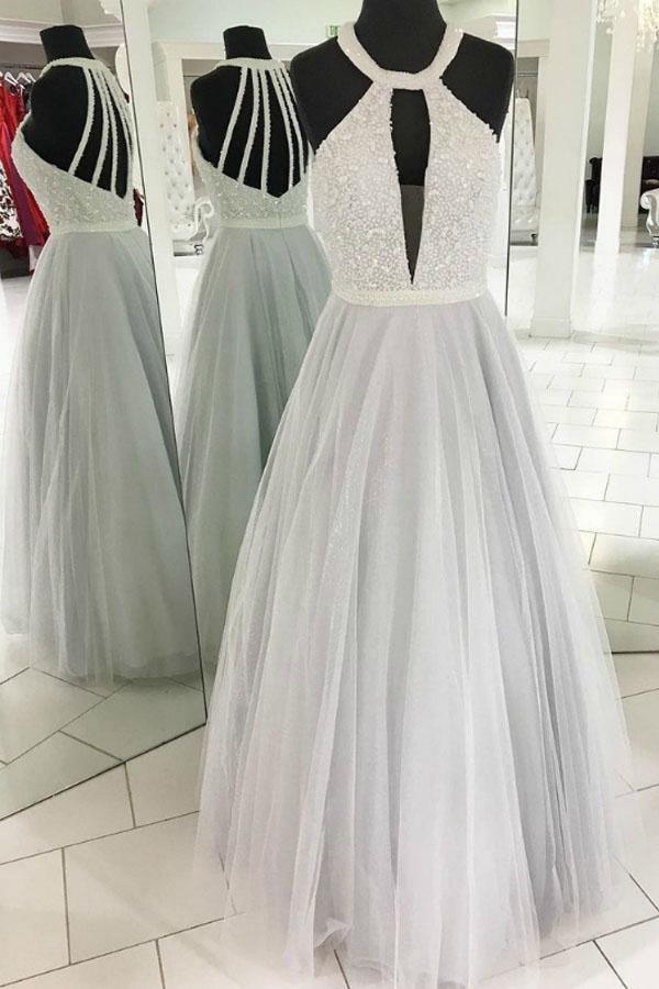 A-line tulle halter prom dress with intricate beading and elegant cut-outs.