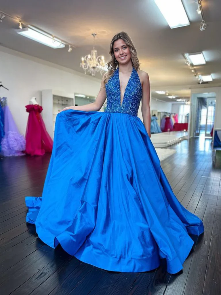 Model wearing an elegant halter V-neck backless A-line long prom dress.