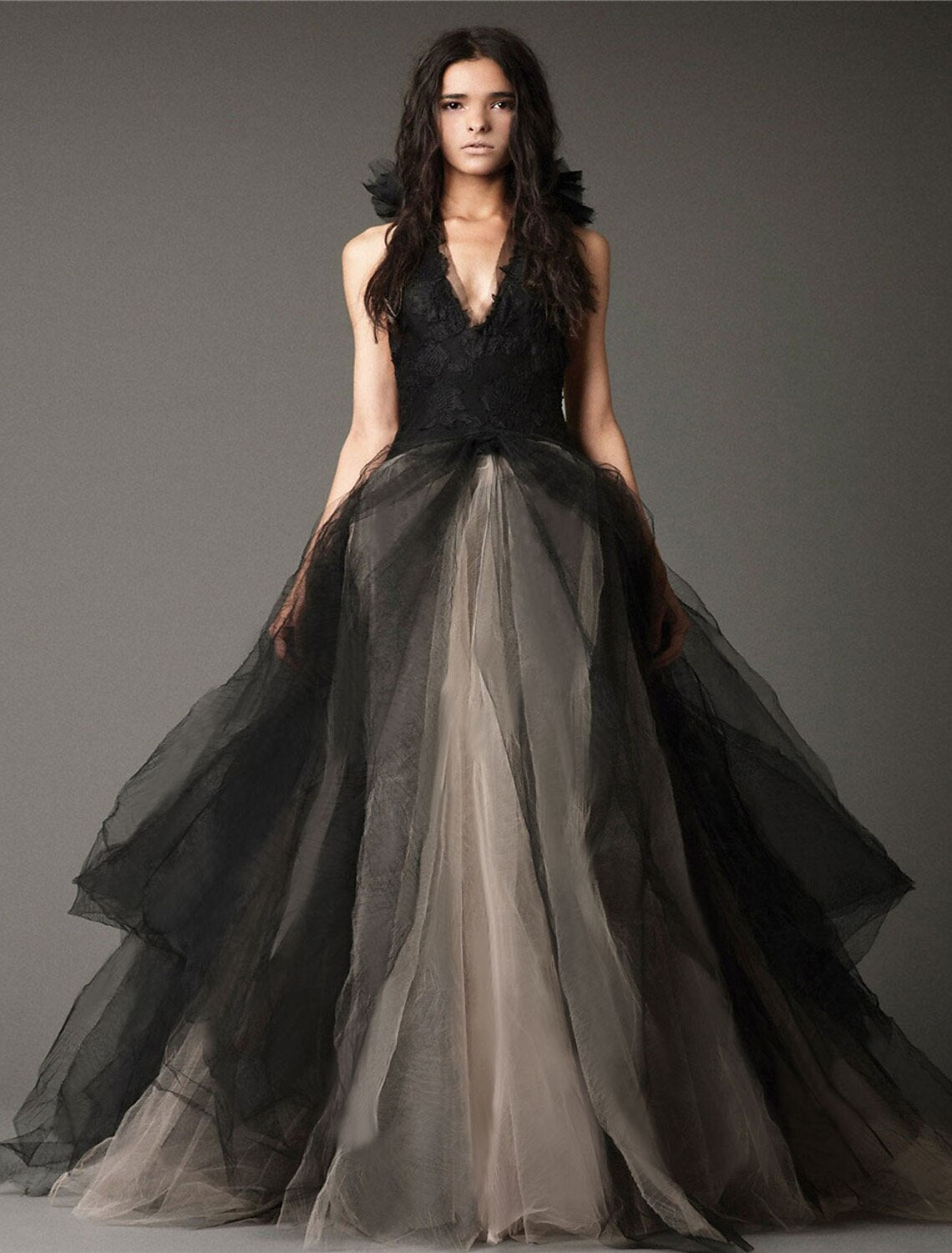 Black A-line halter V-neck wedding dress with lace and tulle appliques.