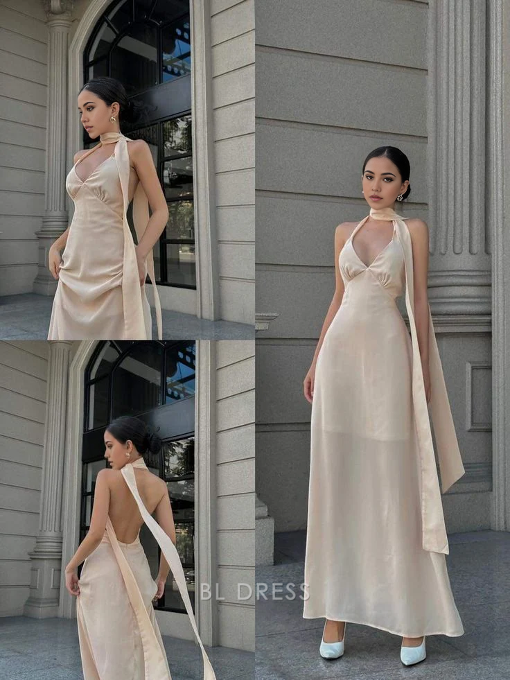 Woman wearing an elegant navy A-line halter V-neck floor-length formal gown.