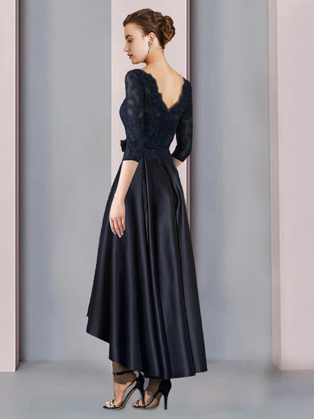 Back view of the elegant A-Line high-low tea length dress, showcasing lace appliques and pleats.