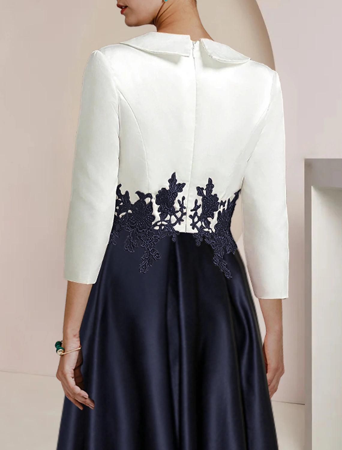 Close-up of the satin and lace fabric with color block detail.