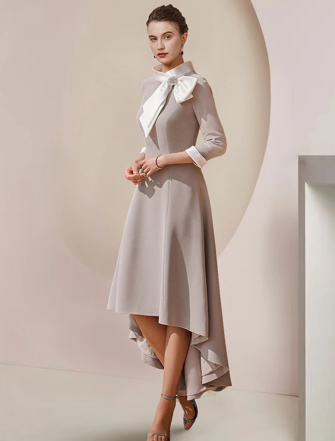Elegant A-Line satin tea length dress with high neck and 3/4 sleeves.