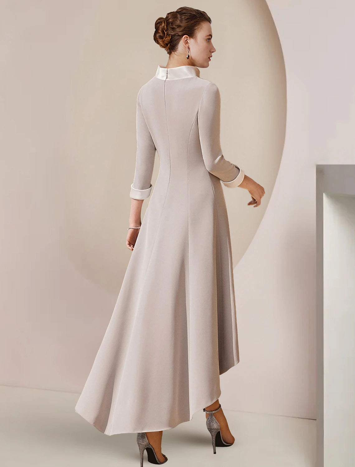 Back view of the A-Line satin dress showing asymmetrical detail and bow.