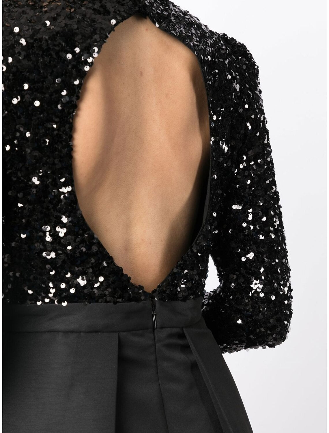 Close-up of the sequin embellishments on the black cocktail dress.