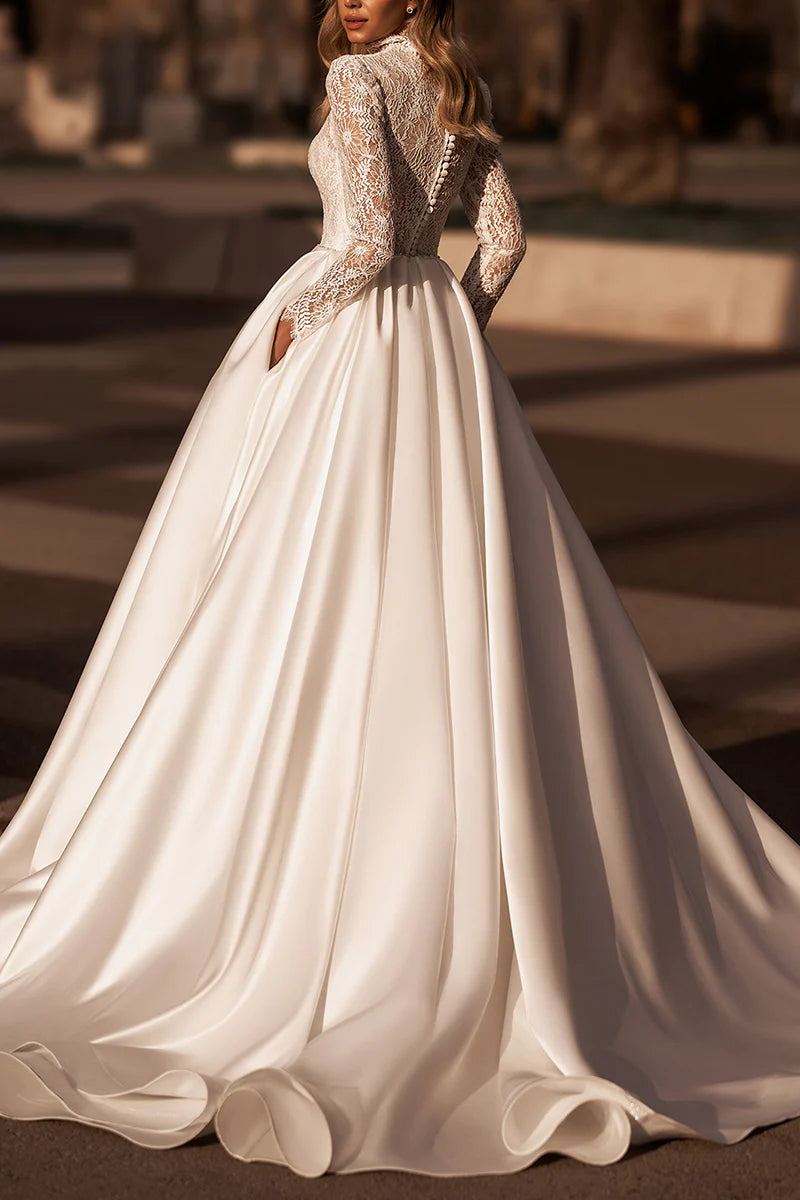 Back view of an A-line wedding dress with long lace sleeves.