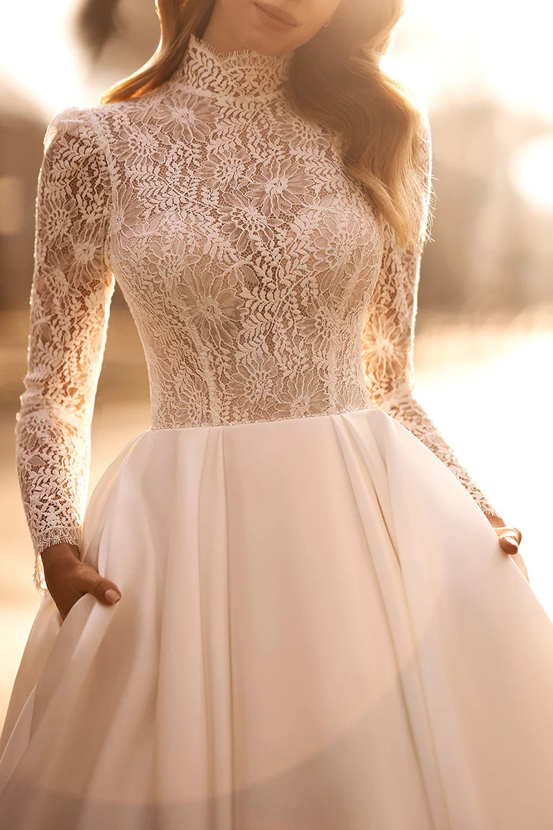 Full view of an A-line high neck lace long sleeve wedding dress.