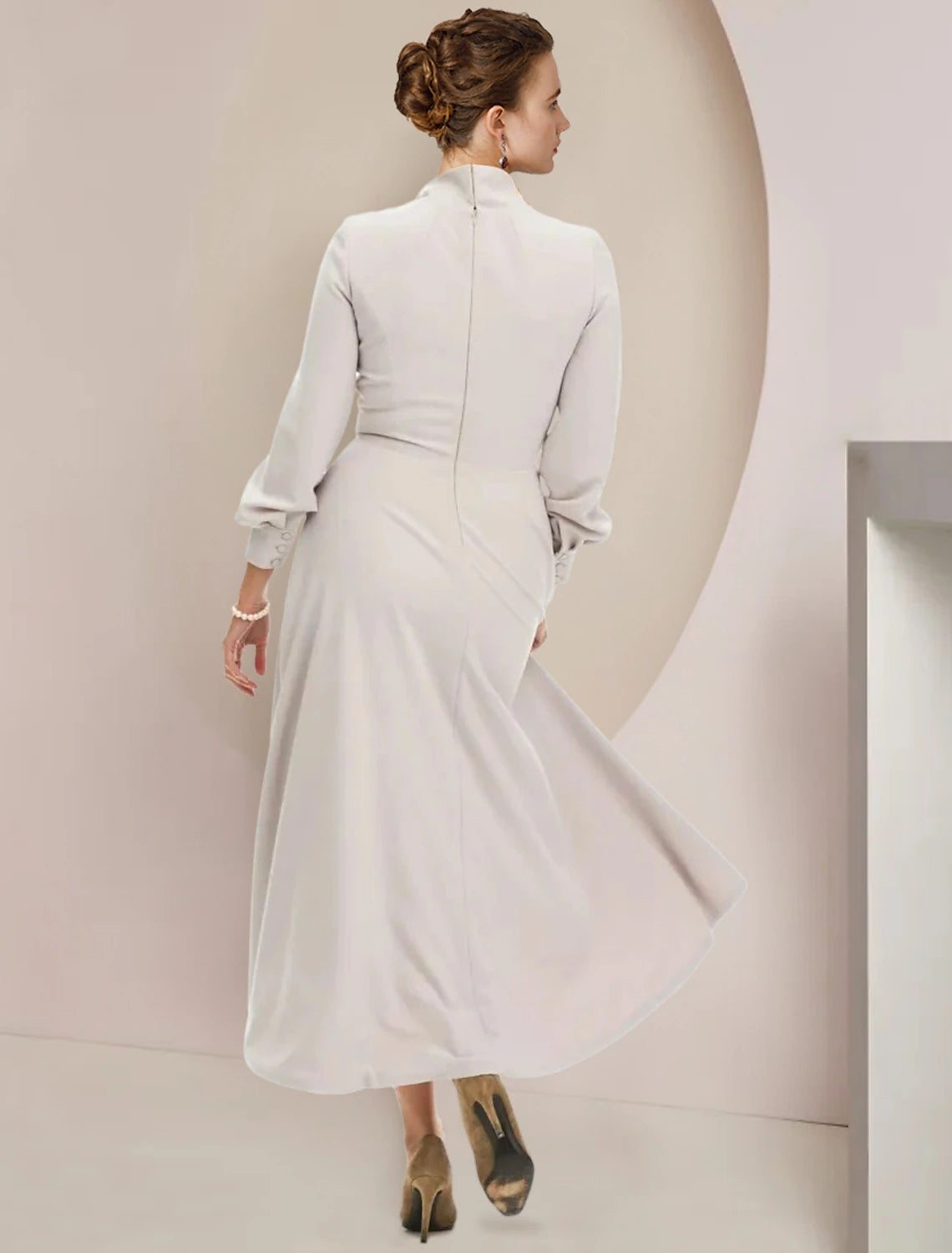 Back view of the A-line Mother of the Bride dress, showcasing tea length and flowing chiffon.