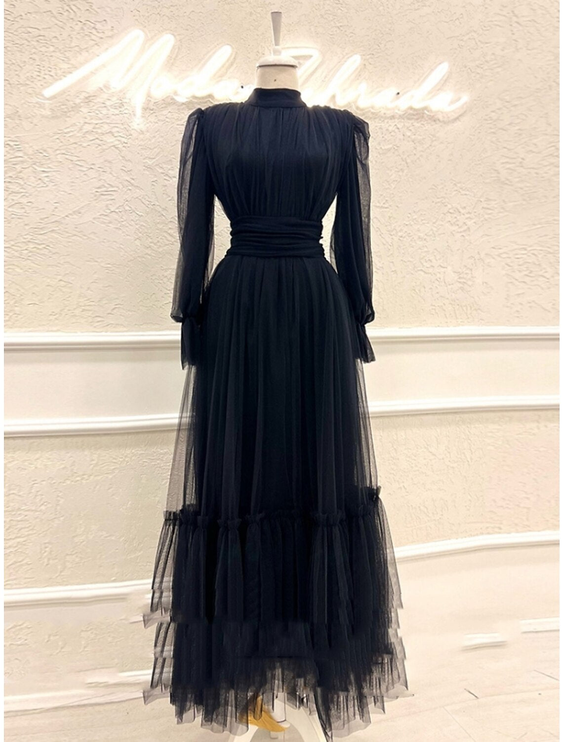 Elegant A-line prom dress with high neck and long sleeves.