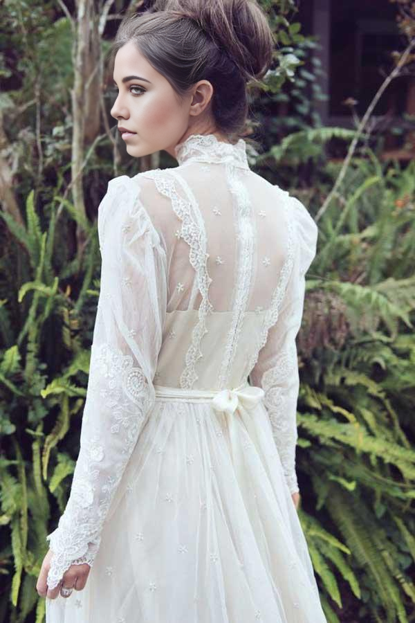 Back view of an A-line wedding dress featuring a high neck and lace details.