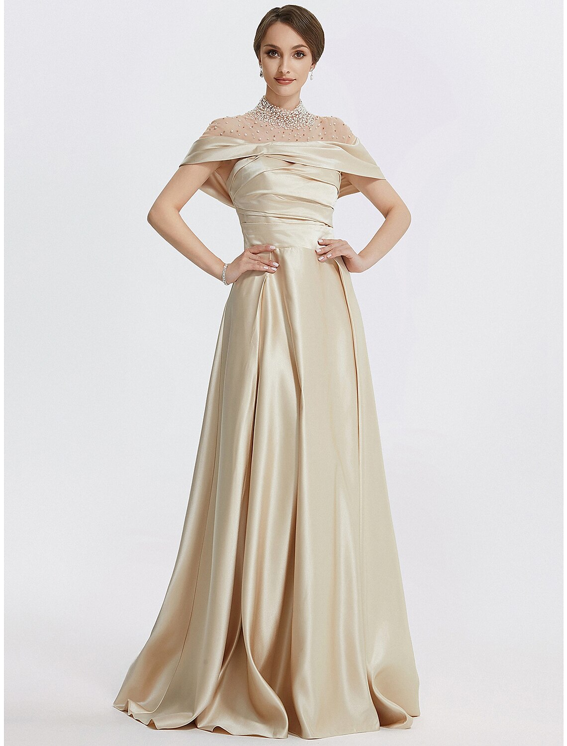 Detail of the ruched fabric and pearl accents on the A-line evening dress.