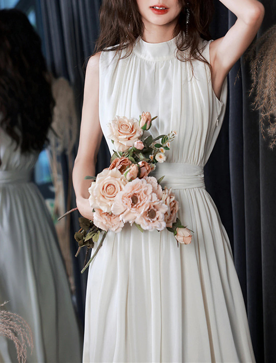 Close-up of the high neck and pleated bodice of a white chiffon dress.