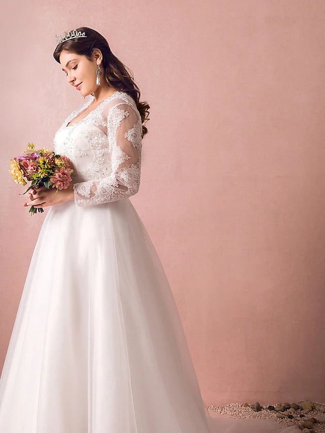 Close-up of the illusion neckline and long sleeves on a satin wedding dress.
