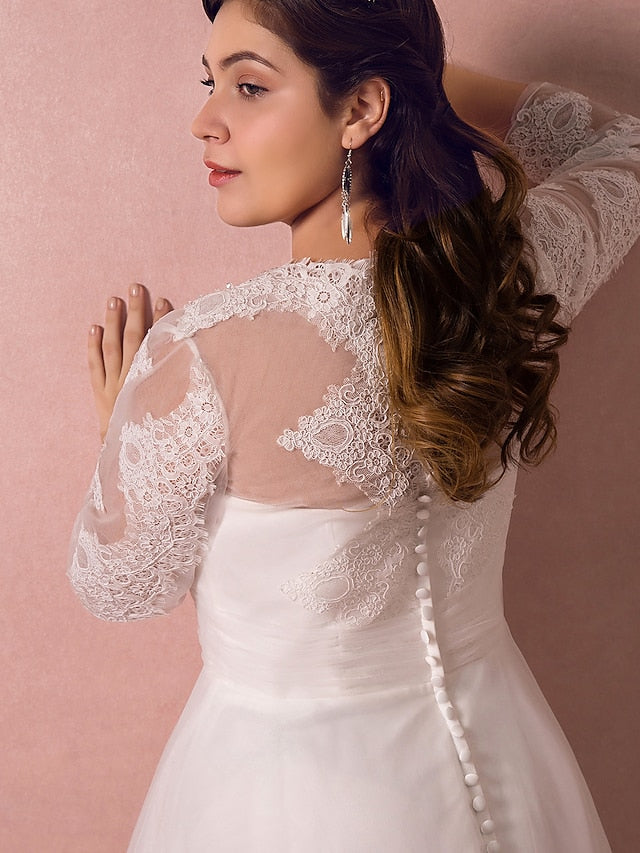 Full length view of a bride in a classic A-line wedding dress.