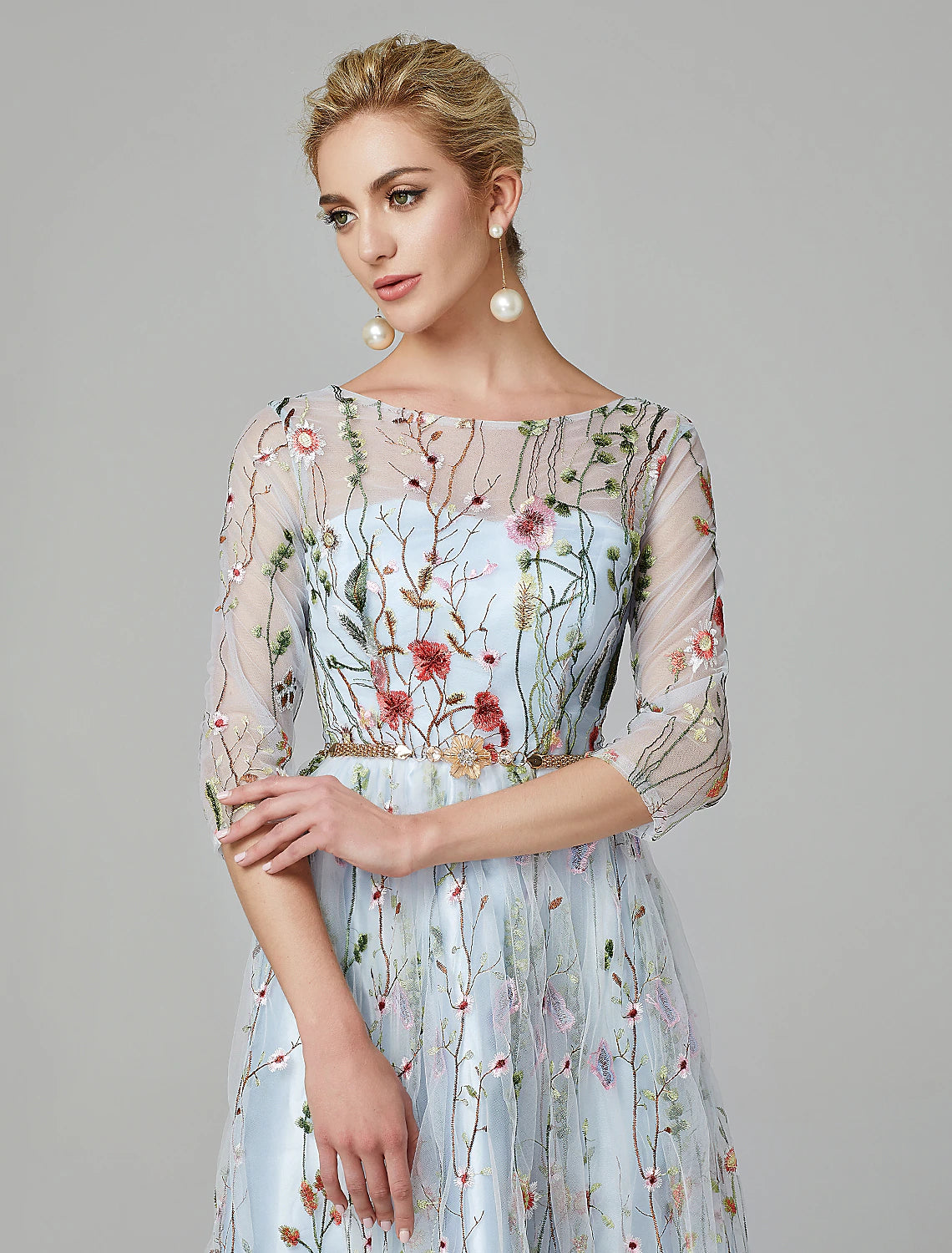 Side view of the floor-length A-Line gown, highlighting the floral lace details.