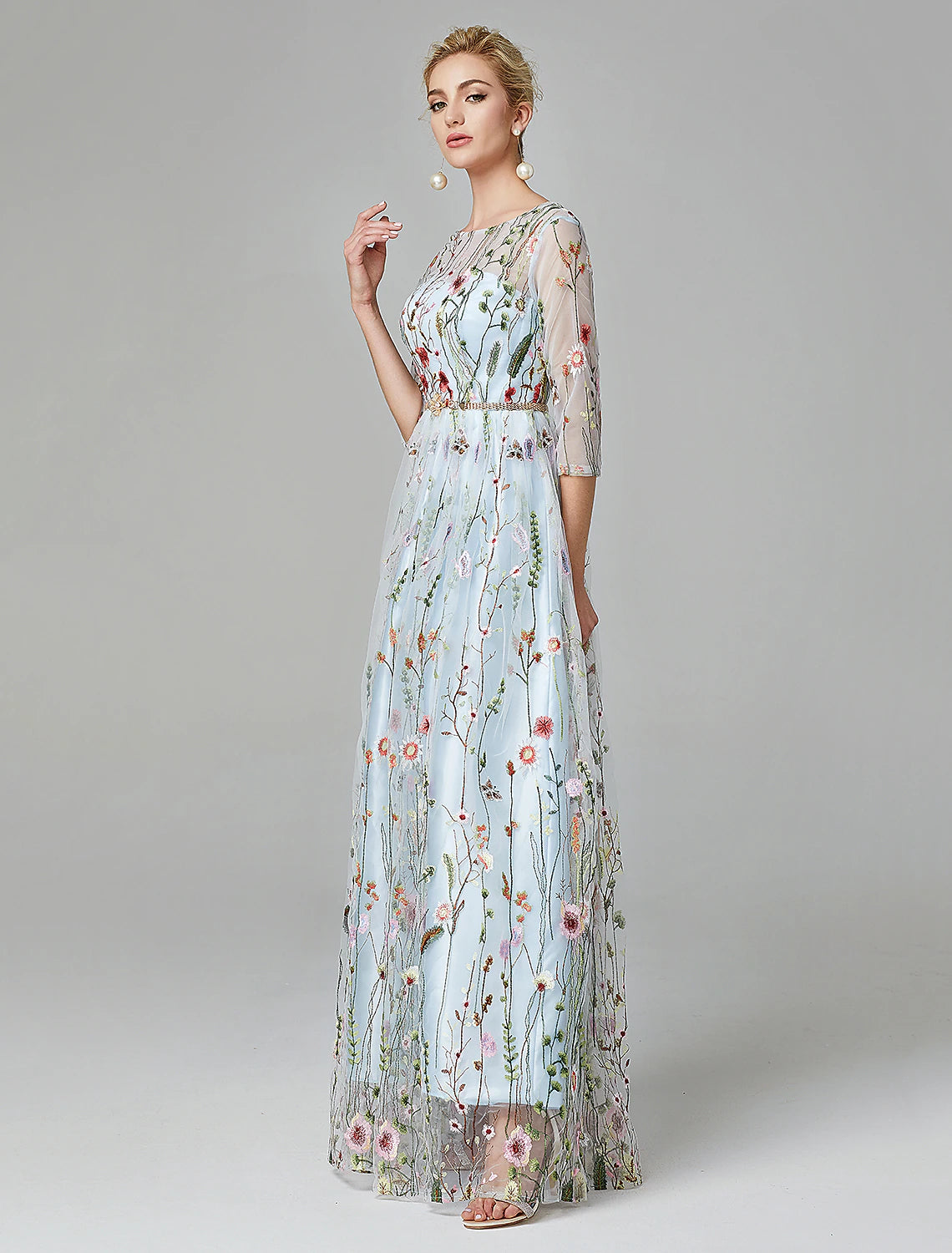 Close-up of the illusion neckline and 3/4 sleeve on the evening gown.
