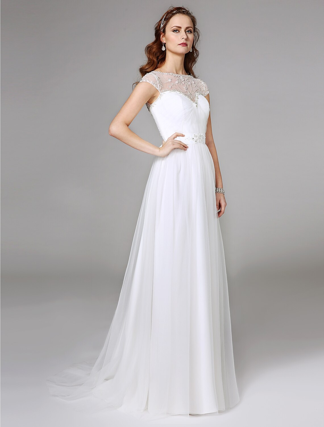 Back view of the A-line wedding dress, featuring intricate beading and lace on the illusion back.