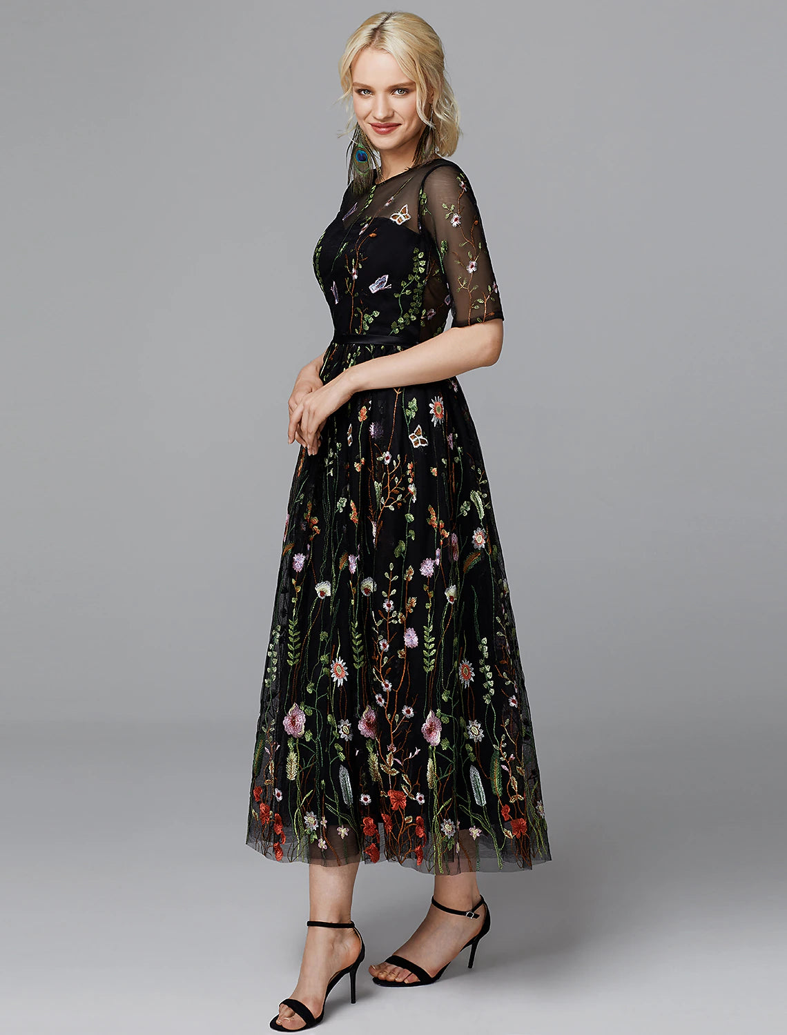 Detail of illusion neckline and delicate half sleeve on floral lace dress.