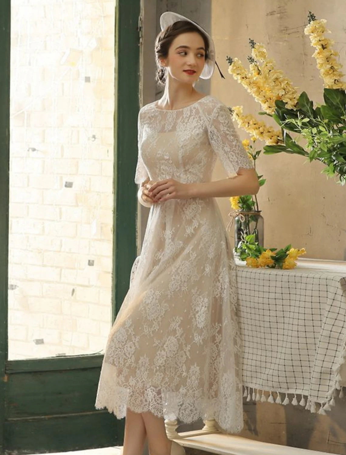 Elegant A-line tea length wedding dress with illusion neckline and half sleeves.