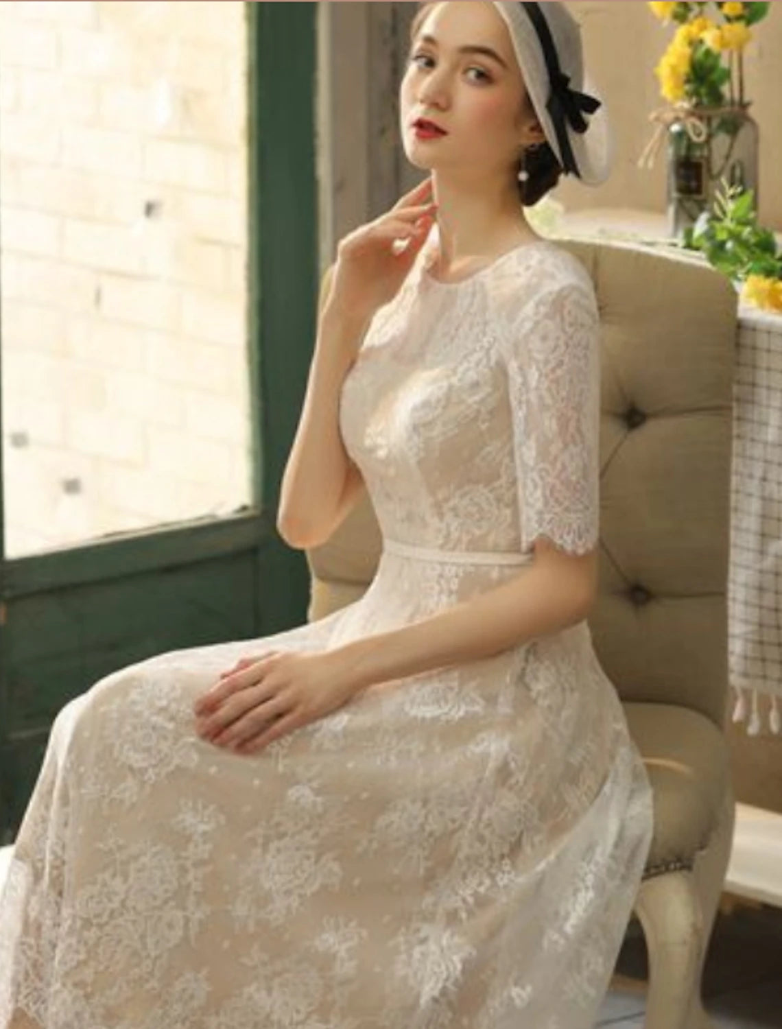 Side view of white lace A-line reception dress.