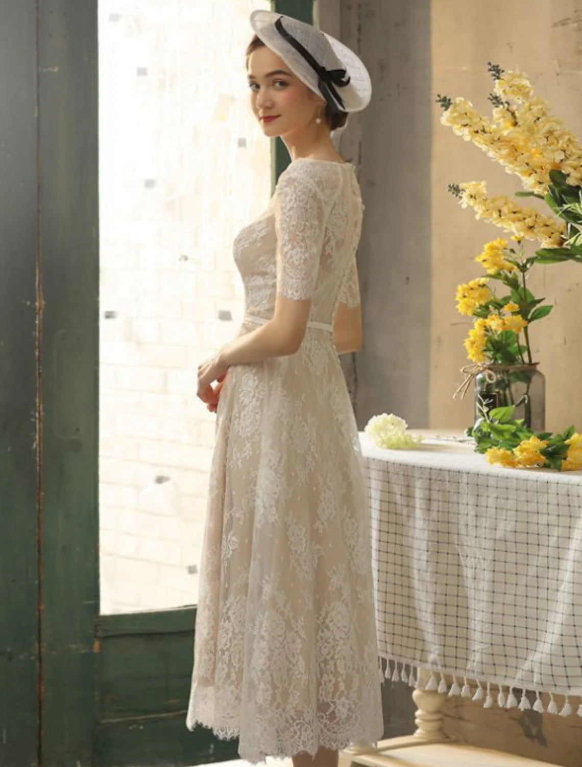 Back view of bridal gown featuring sash and ribbon appliques.
