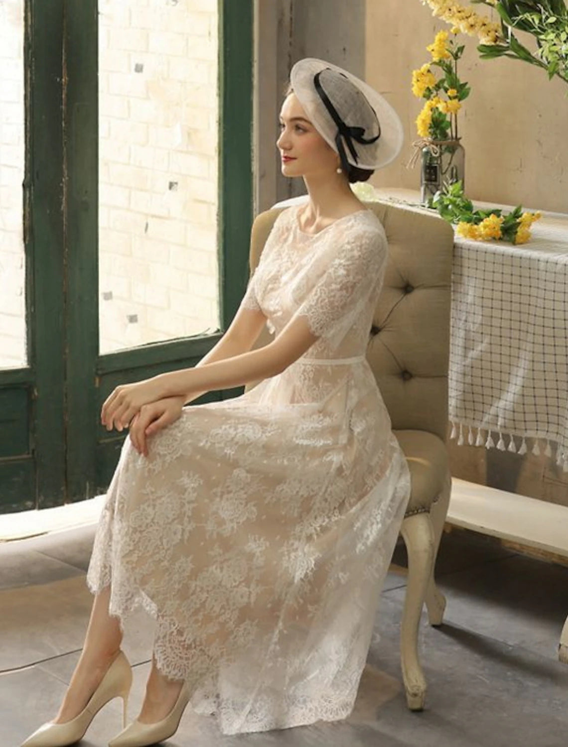 Close-up of lace detail and half sleeve on wedding dress.