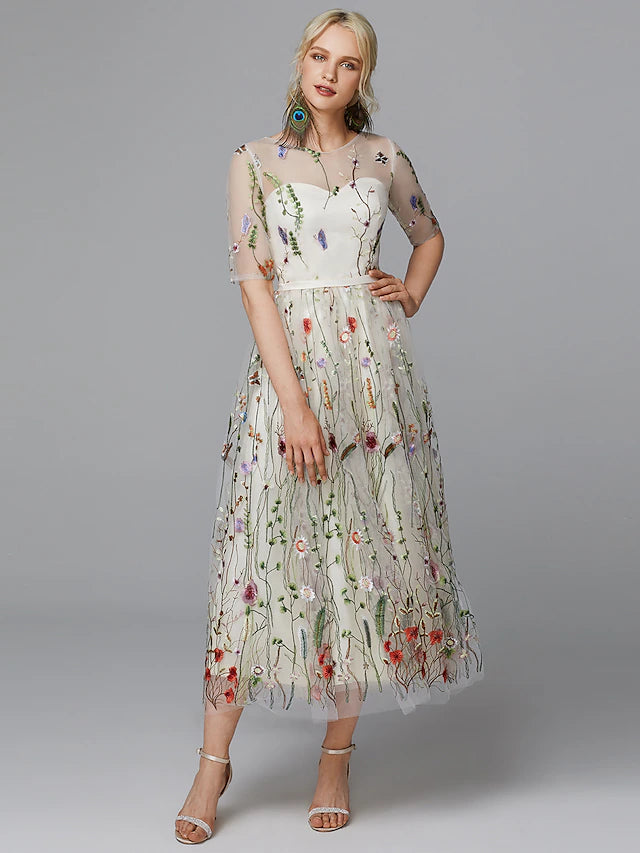 Detail of lace and embroidery appliques on white dress.