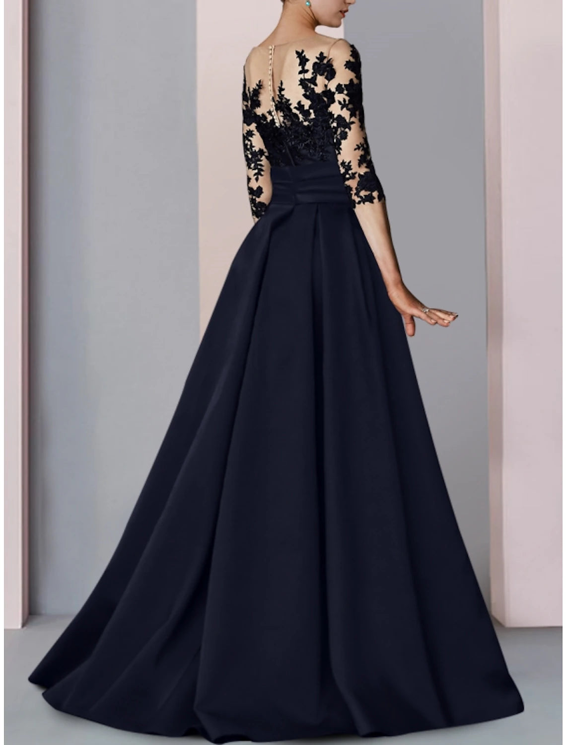 Woman posing in the A-line satin gown, showing the full silhouette.