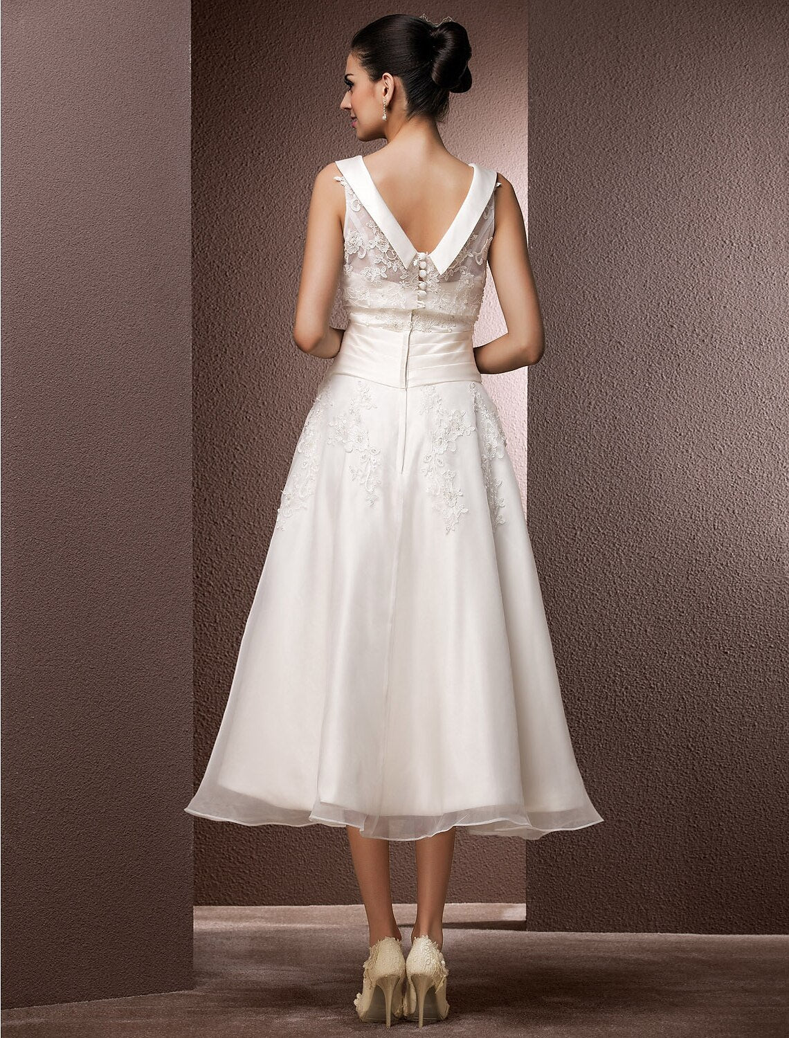Side view of the elegant tea length wedding gown, highlighting the A-line silhouette.