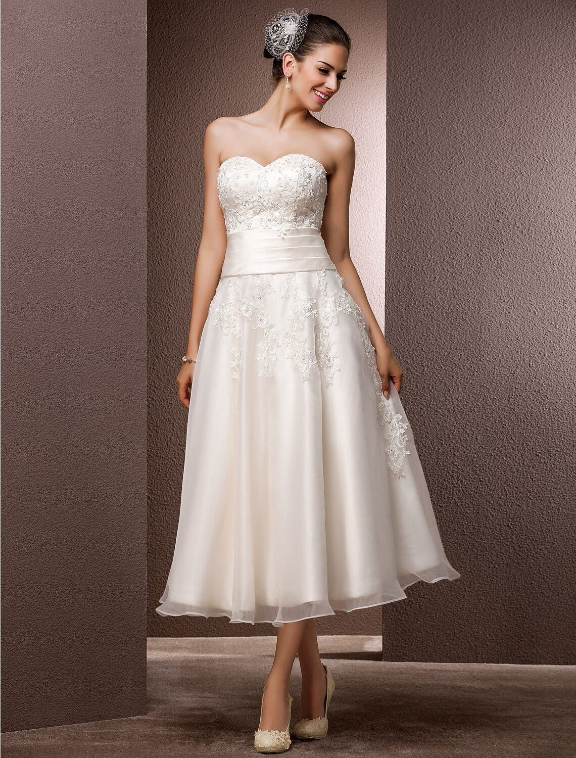 Close-up of the illusion neckline and intricate lace with pearl beading on the wedding dress.