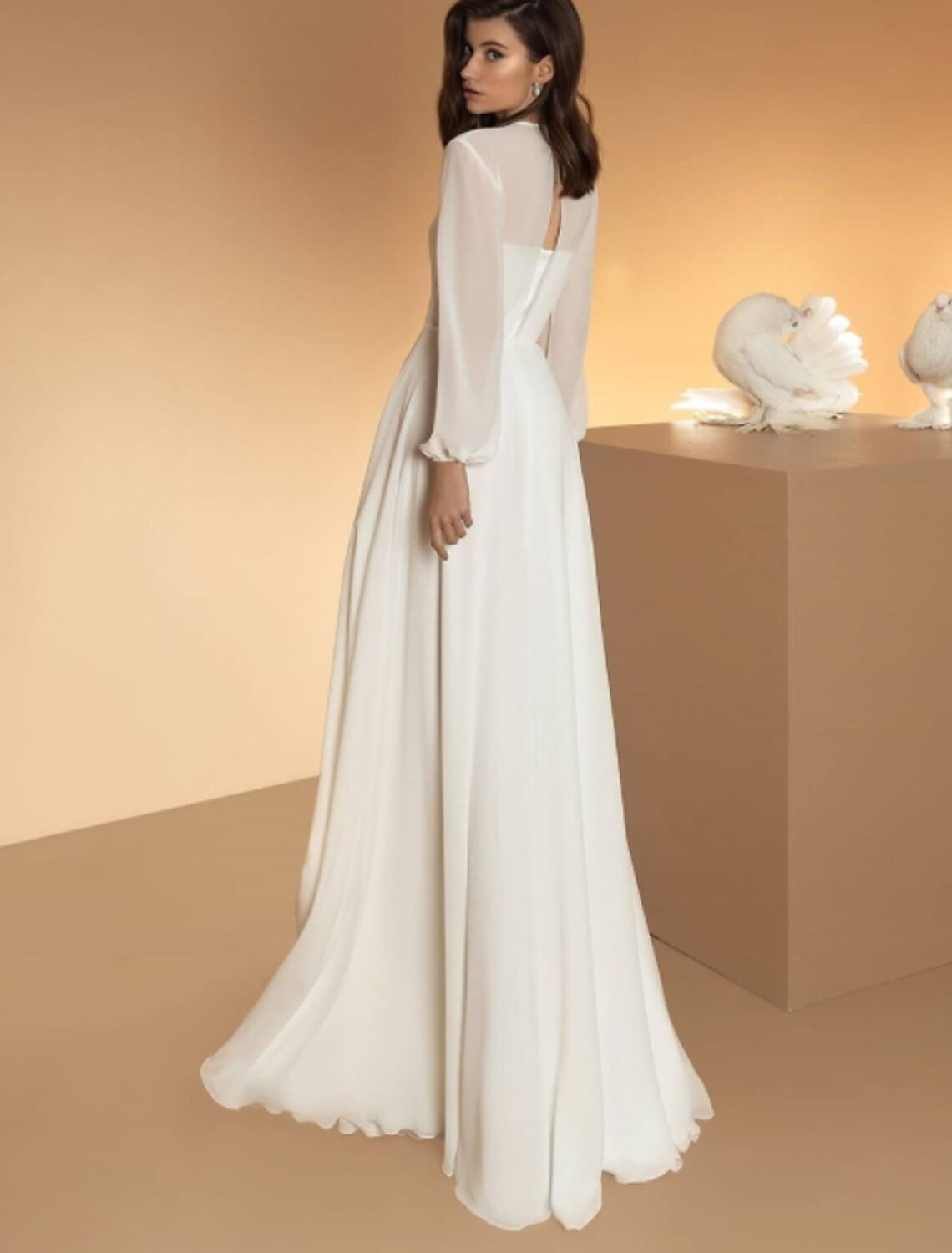 Back view of a floor-length A-line chiffon bridal gown.
