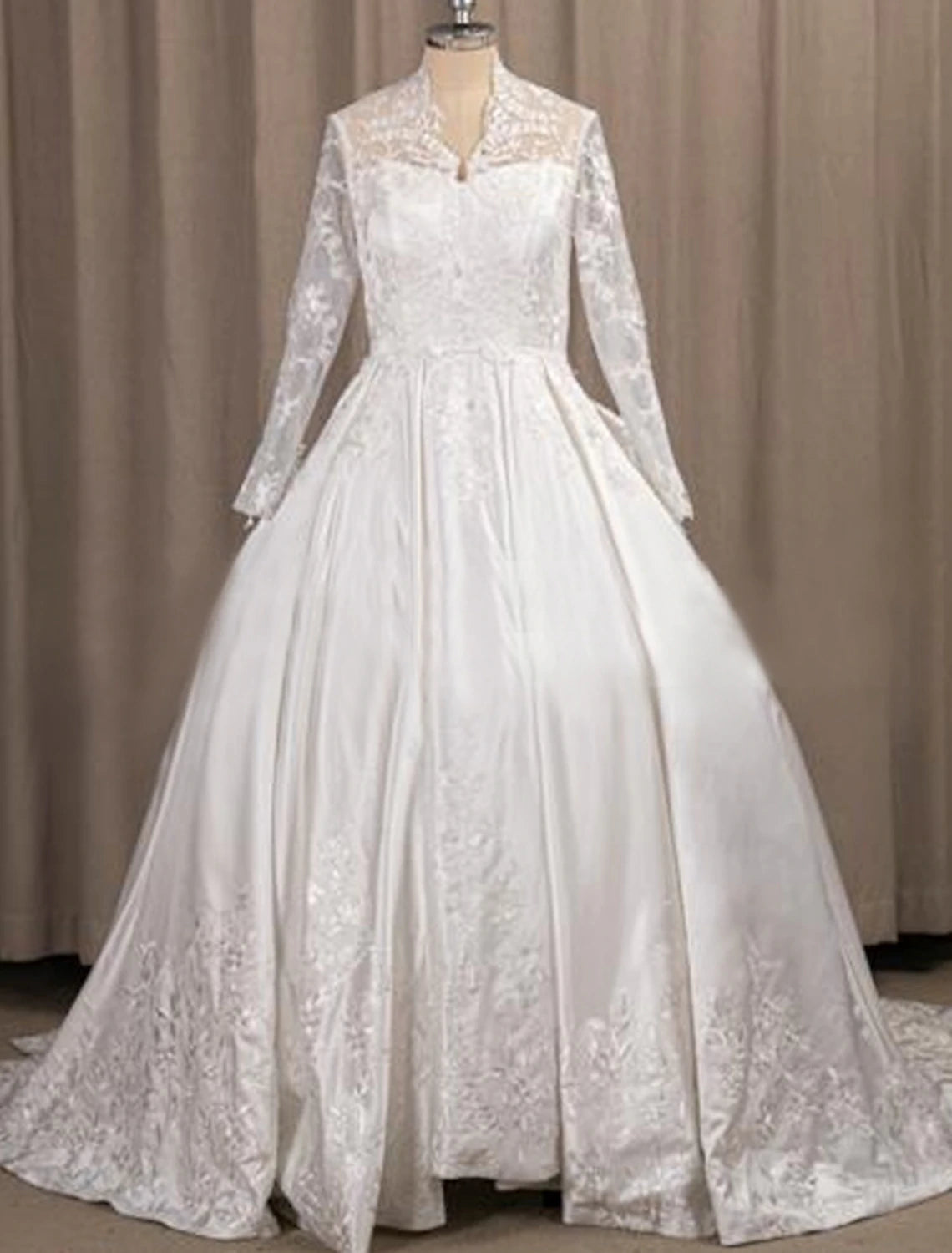 Elegant A-Line satin bridal gown with illusion neck and long sleeves.