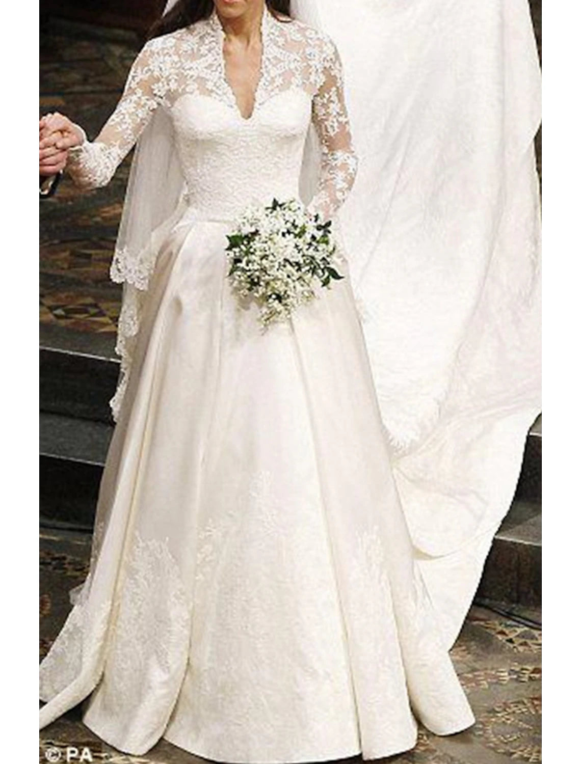 Close-up of illusion neckline and delicate appliques on bridal gown.