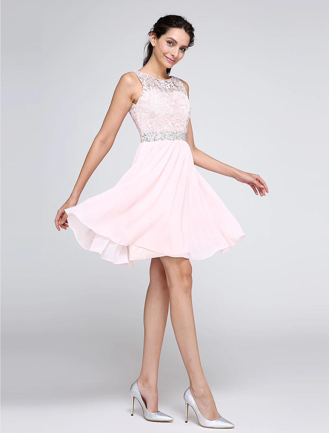 Side view of a short mini pink A-line cocktail dress, showcasing its graceful silhouette.