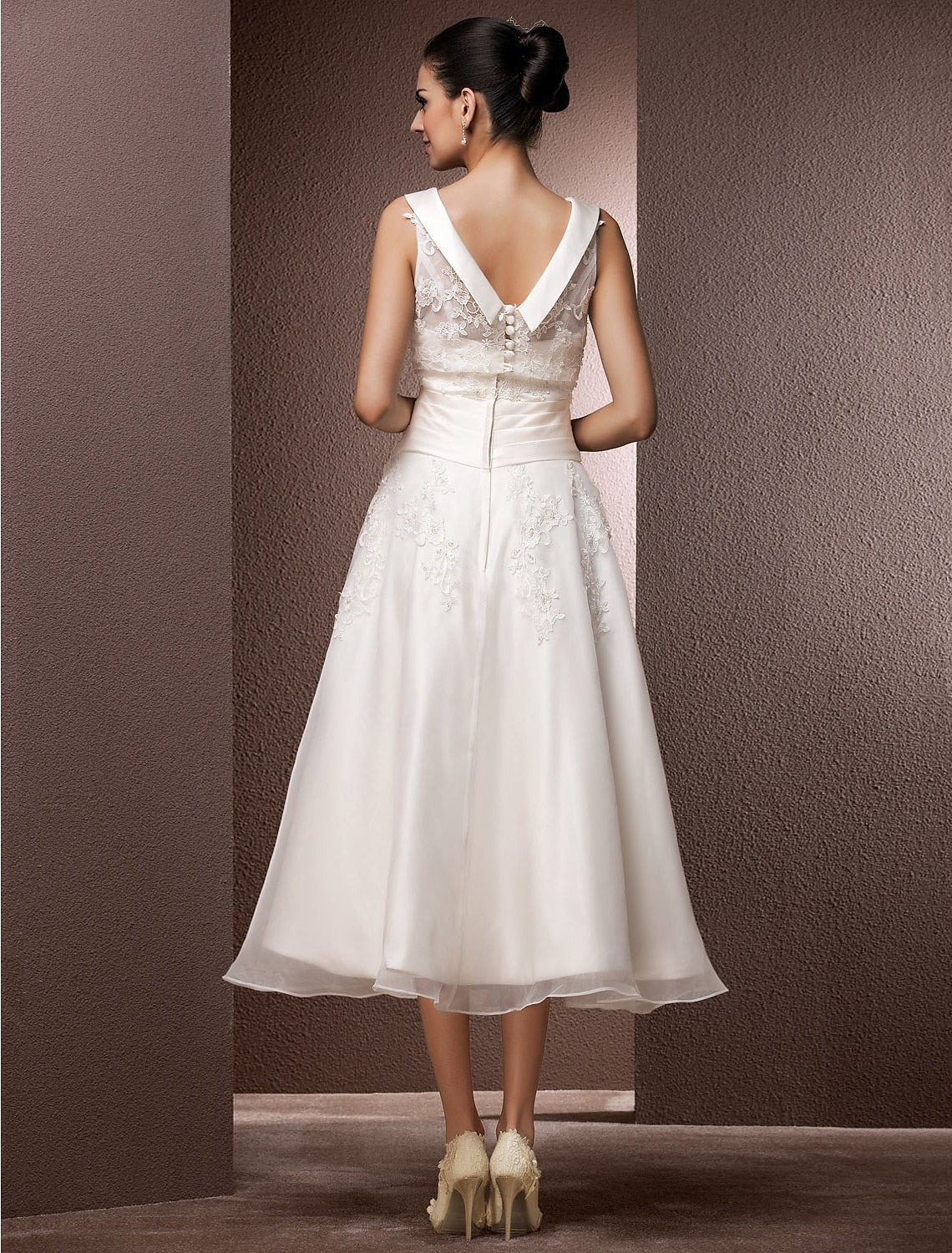Close-up of the lace and pearl beading on the wedding dress bodice.