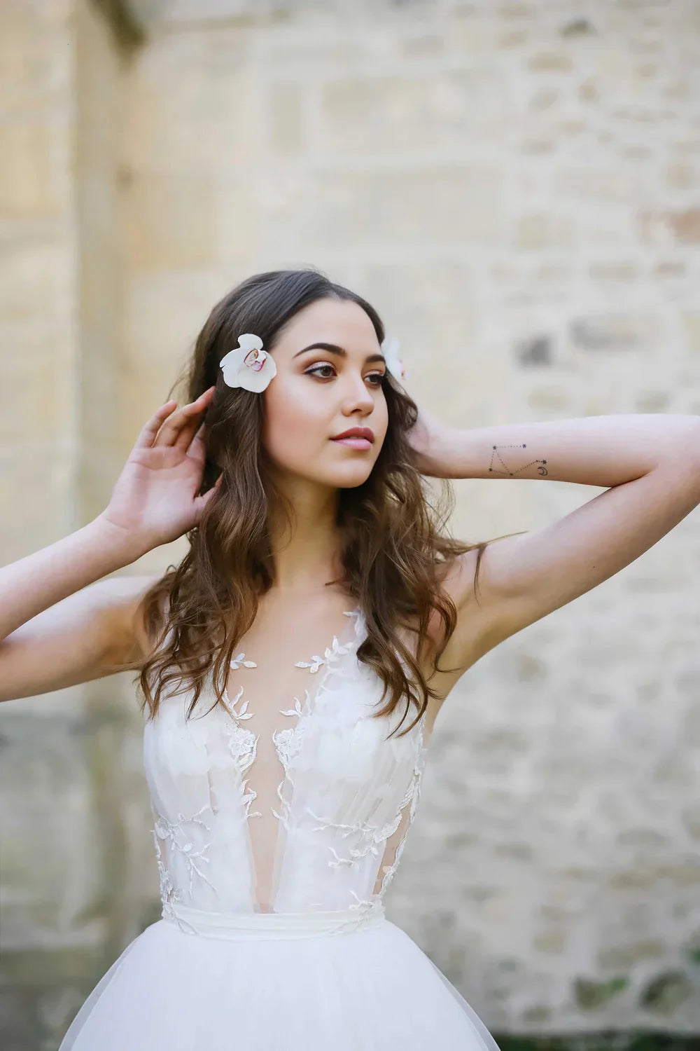 Elegant A-line wedding dress with illusion V-neck and delicate tulle appliques.