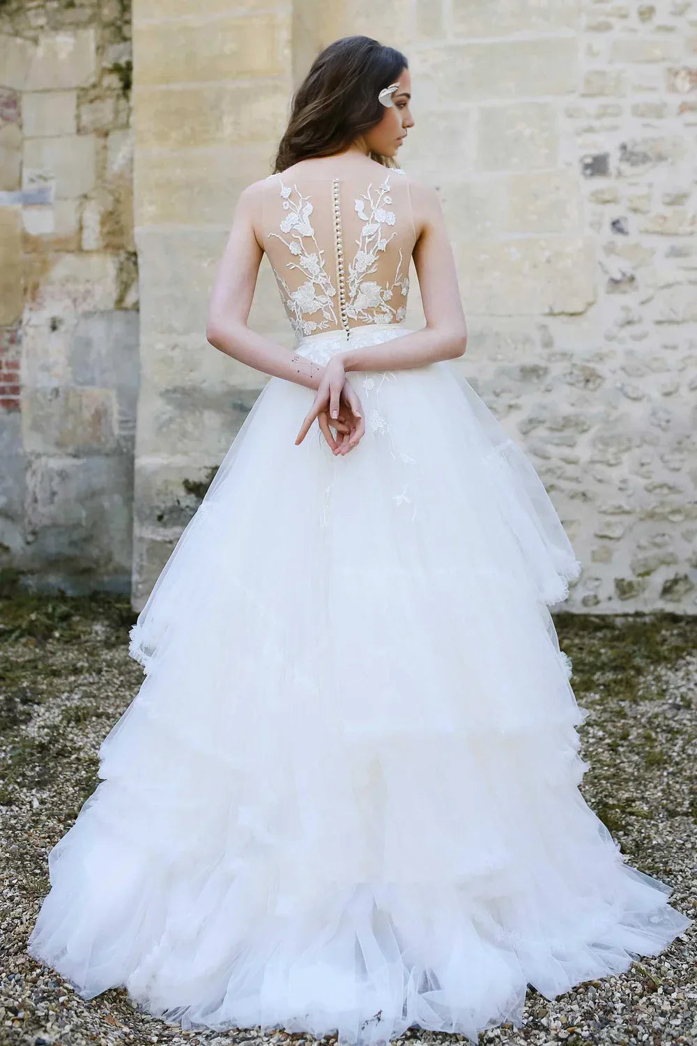Side view of the A-line bridal gown, highlighting tulle fabric and applique details.