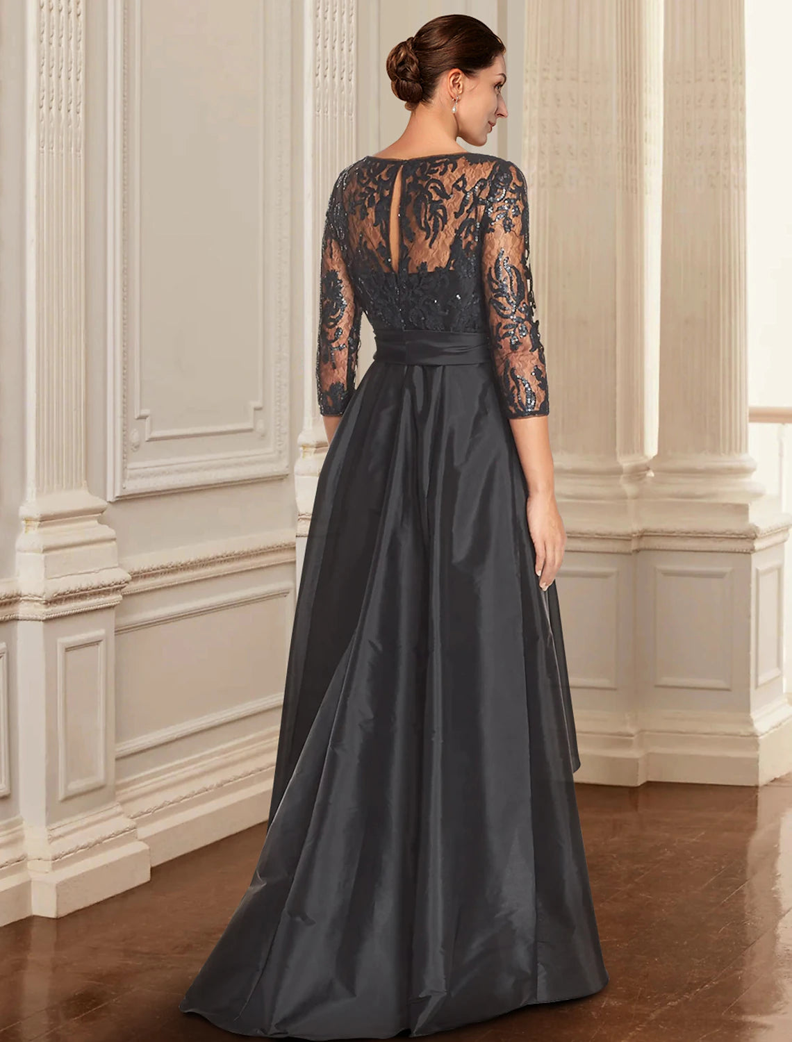 Back view of the A-line black dress, highlighting lace and sequin embellishments.
