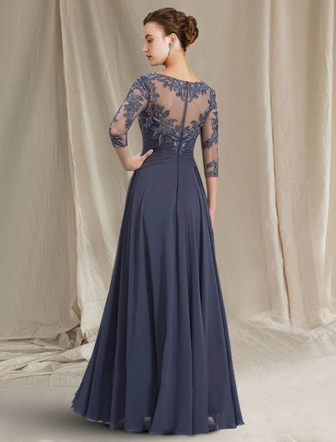 Back view of floor length chiffon lace dress with pleats and appliques.