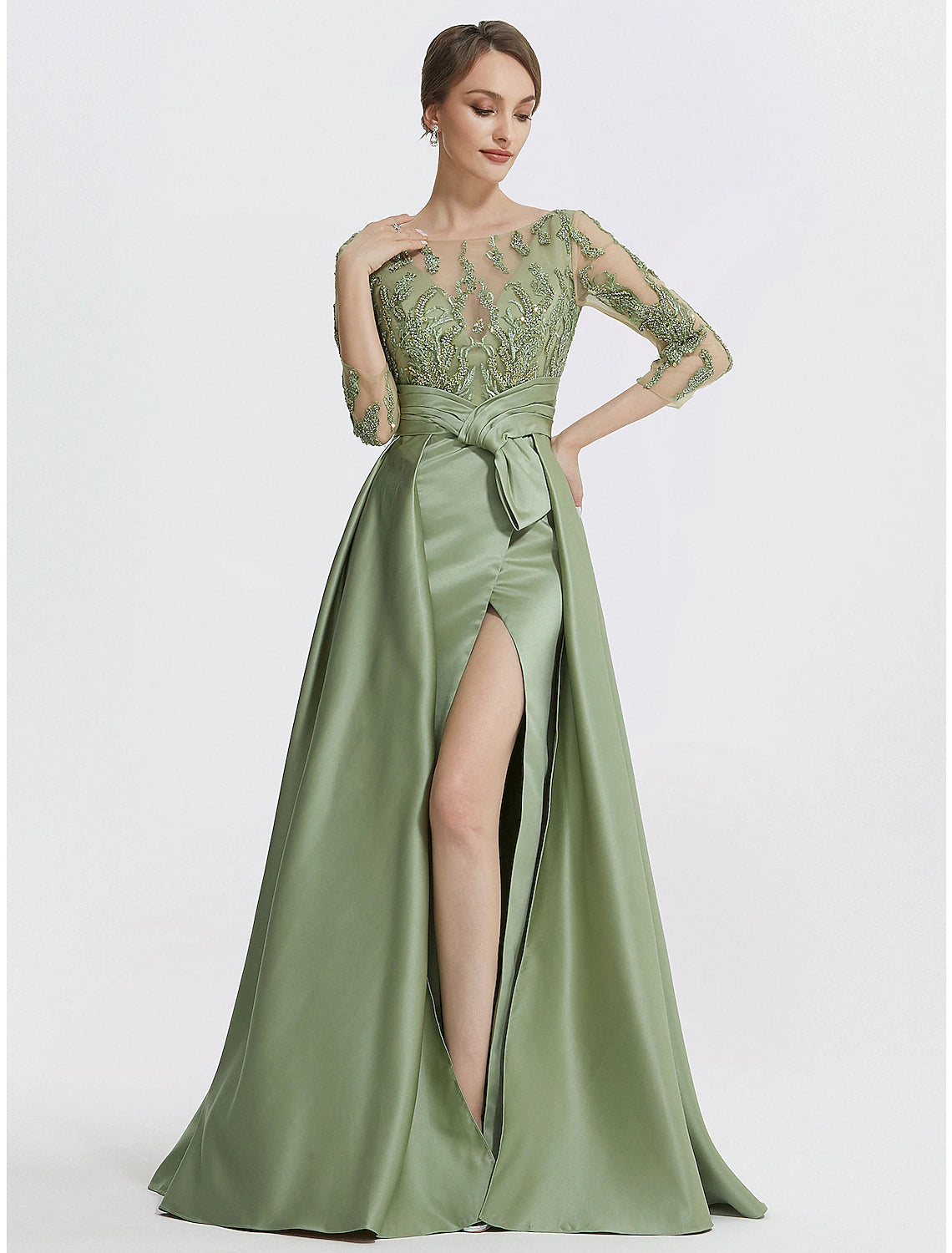 Close-up of the embroidered details and appliques on the elegant satin gown.